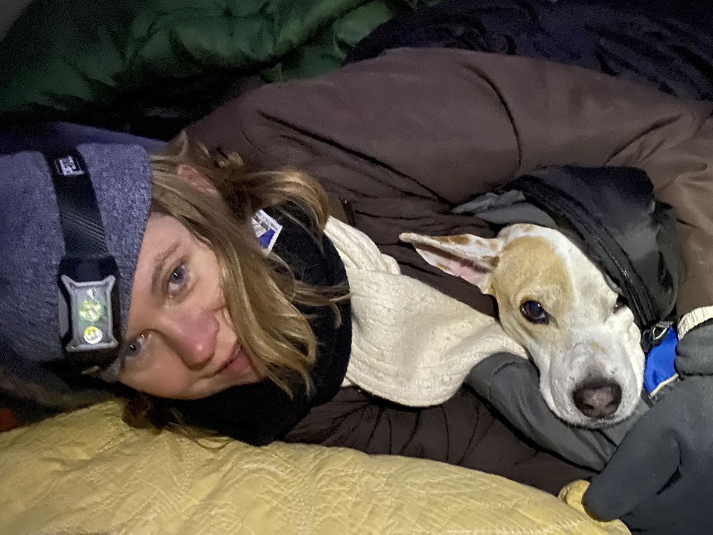 Rebecca claiming some warmth from our dog Oscar