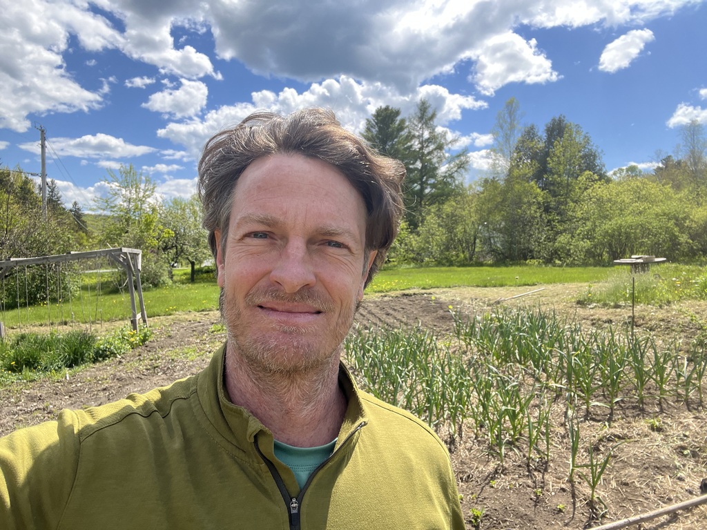 Me standing in front of the Garlic in the garden
